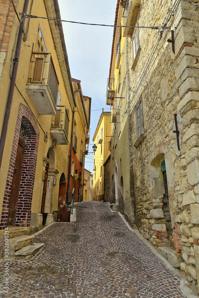 A narrow street among the old houses of Mirabello Sannitico, a medieval village in the province of Campobasso, Italy