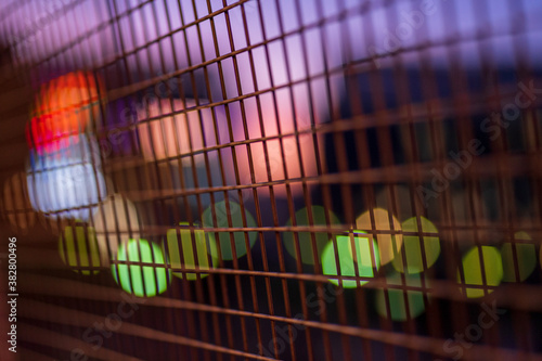 Bokeh lights behind fence