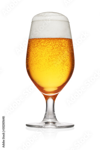 Glass of light yellow beer isolated on white.