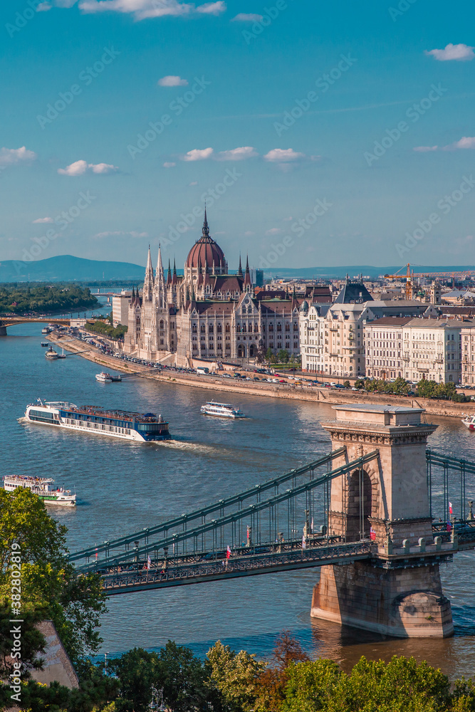The panorama view of the skyline in Budapest, Hungary, with Széchenyi Lánchíd over the Danube, and  the parliament building in Hungary.