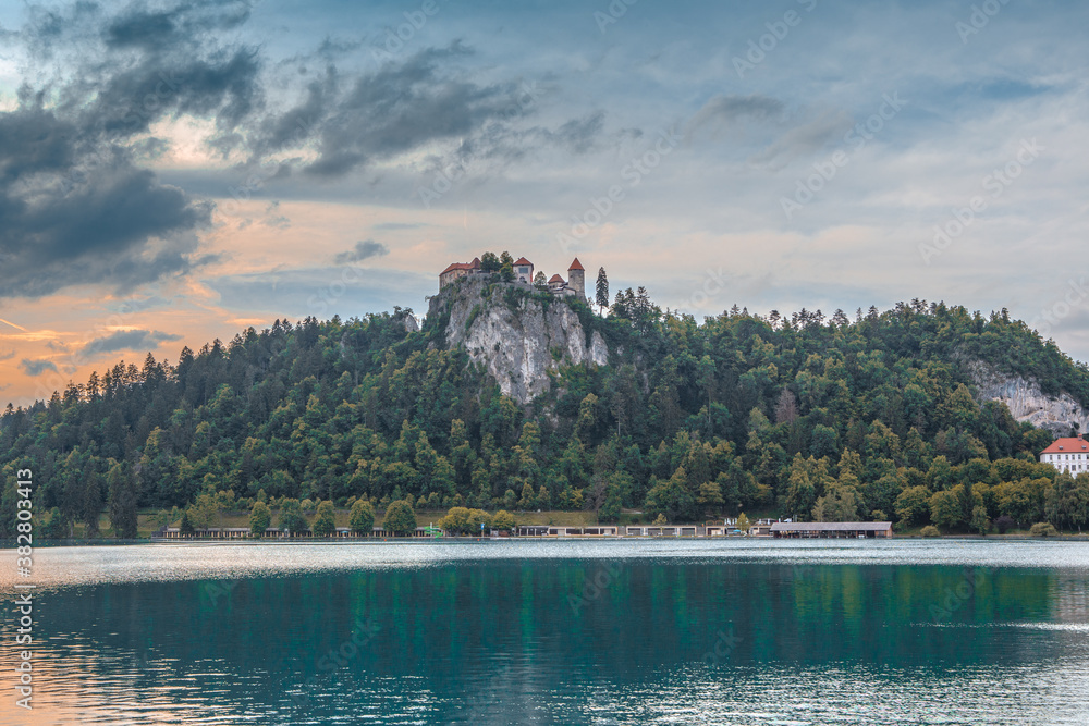 Naklejka premium Sunset view of Bled castle on the hill, in Slovenia.