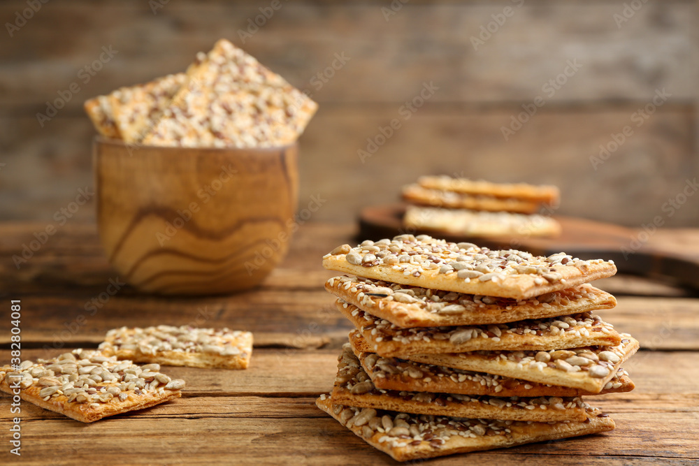 Stack of delicious crackers on wooden table