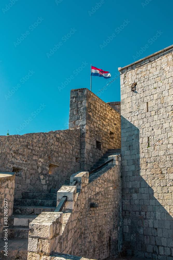 A croatian national flag on top of the Hvar Fortress, in Hvar island, Croatia.