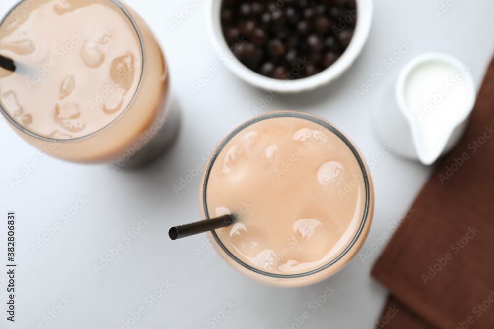 Bubble milk tea and bowl with tapioca balls on light grey table, flat lay Bubble milk tea and bowl with tapioca balls on light grey table, flat lay