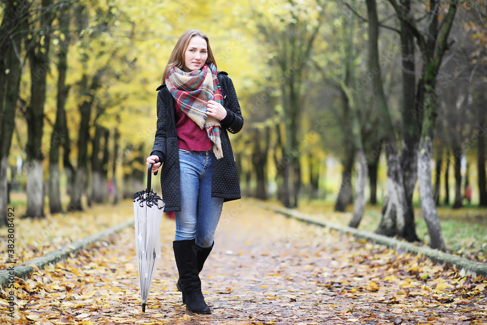 Young girl on a walk in the autumn park Young girl on a walk in the autumn park