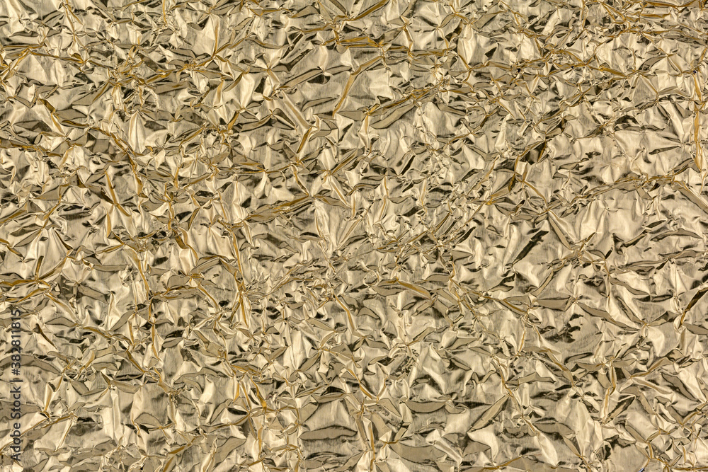 Crumpled gold foil as background, texture, pattern. Crumpled gold foil as background, texture, pattern.