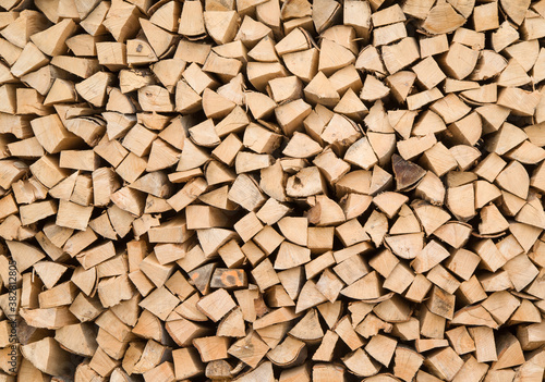 Composition of wood logs for texture  background. Natural wooden logs stacked Stocking up for winter. A pile of cut tree trunks