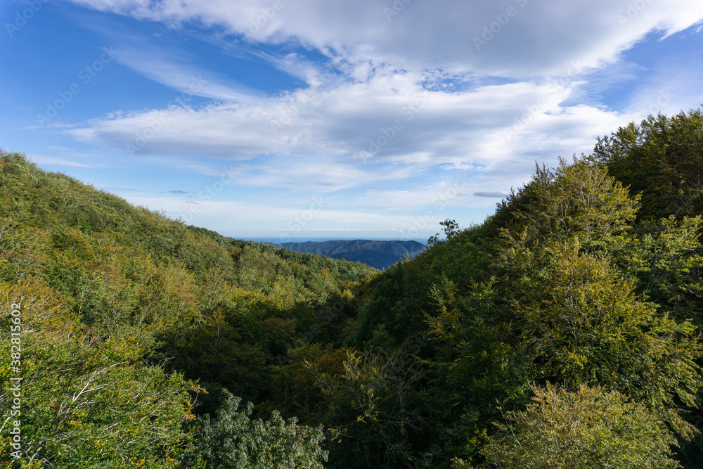 Landscape of mountains in autumn and the Mediterranean sea on the horizon
