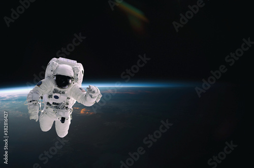 Astronaut walking in space with earth background. Elements of this image furnished by NASA