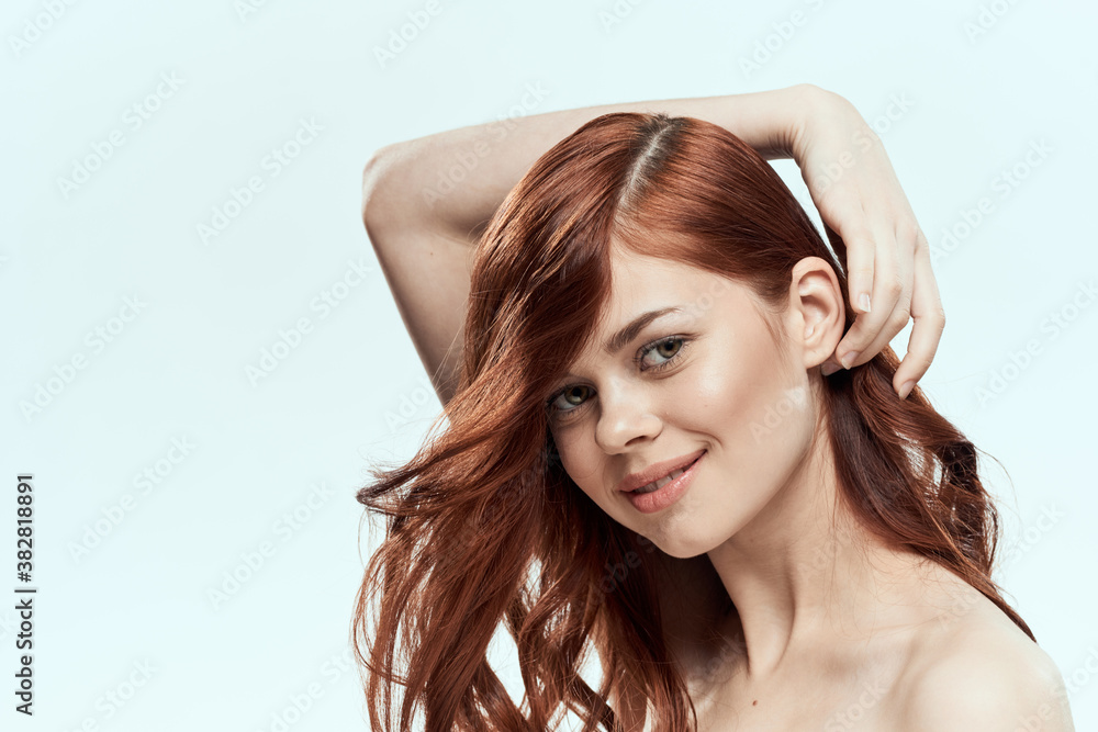 Fototapeta premium Pretty woman holding hair smile cosmetics lifestyle naked shoulders hairstyle care charm light background