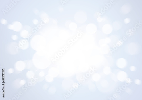 優しい中心から飛び散る光輝く背景玉ボケ　グレー