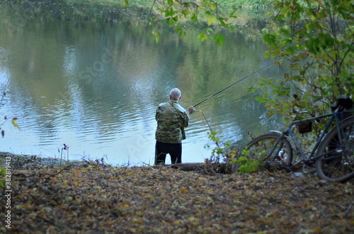 A fisherman catches fish near the river Tsna in the city of Tambov 