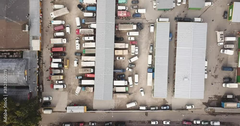 Aerial hyper lapse (hyperlapse - time lapse) of a large logistics park with a warehouse - loading hub. Semi-trucks with freight trailers standing at the ramps for loading/unloading goods Aerial hyper lapse (hyperlapse - time lapse) of a large logistics park with a warehouse - loading hub. Semi-trucks with freight trailers standing at the ramps for loading/unloading goods