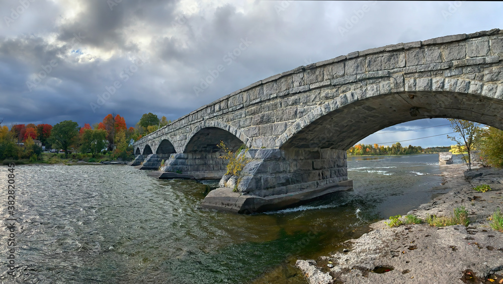 Pakenham Bridge, a five arch stone bridge that crosses the Mississippi River on a stormy autumn day in Pakenham, Canada