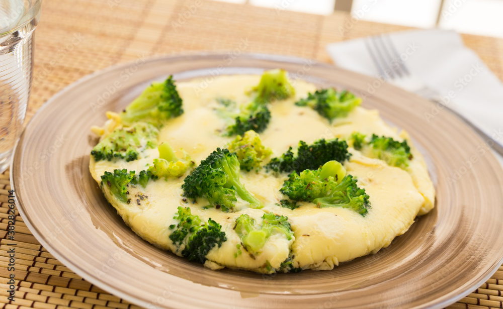 wholesome breakfast. omelet with broccoli on brown plate wholesome breakfast. omelet with broccoli on brown plate