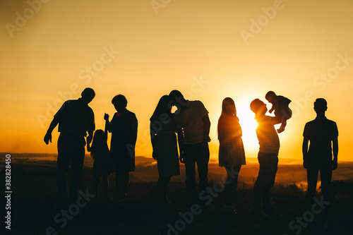 family and beautiful sunset, different generations meet the beautifulsunset