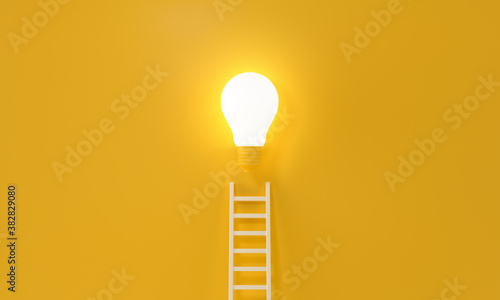 Fotografia Ladder reaches up to a lit light bulb representing an Idea, creativity, invention concept