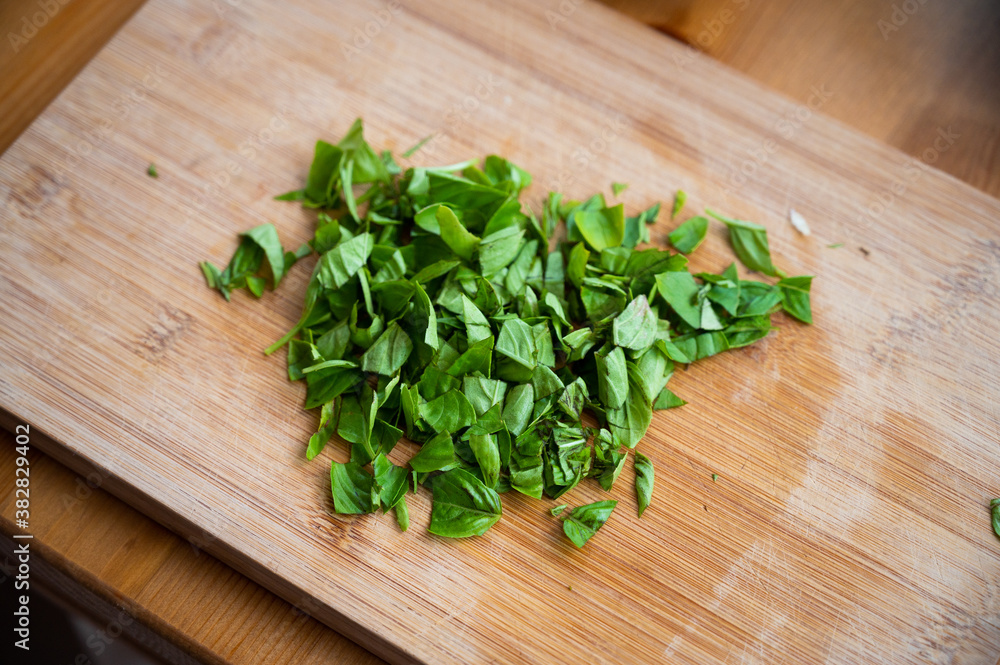 roughly chopped basil on a wooden board roughly chopped basil on a wooden board