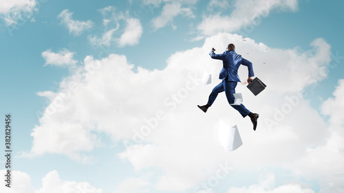 Businessman jumping high in the air © Sergey Nivens