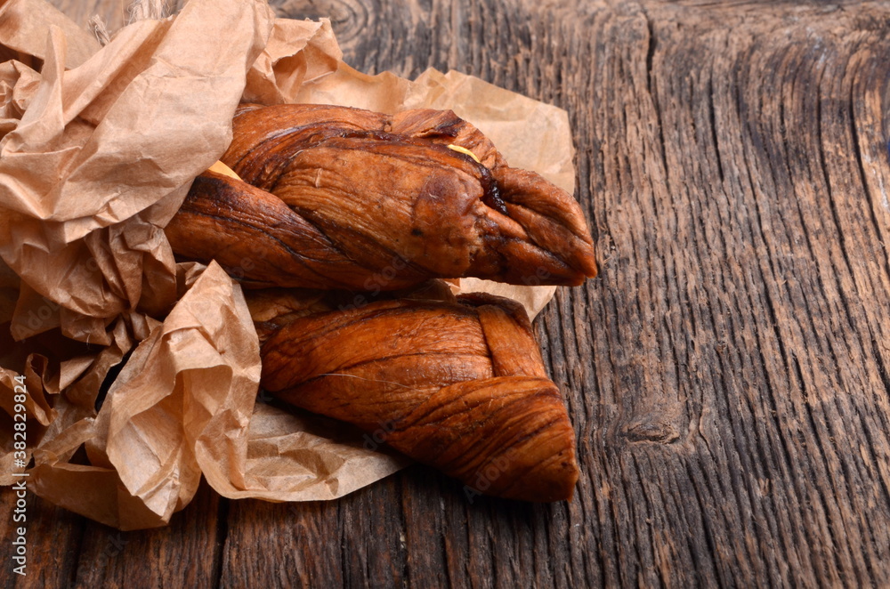 Dried melons in a paper bag, close-up, on a wooden background. Dried melons in a paper bag, close-up, on a wooden background.