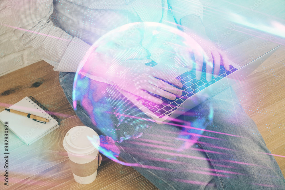 Technology theme hologram with man working on computer on background. High tech concept. Multi exposure. Technology theme hologram with man working on computer on background. High tech concept. Multi exposure.