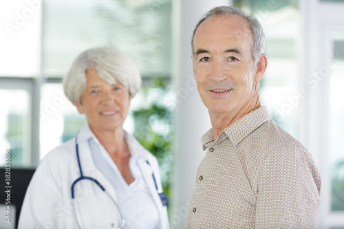 doctor visiting disabled senior patient at home