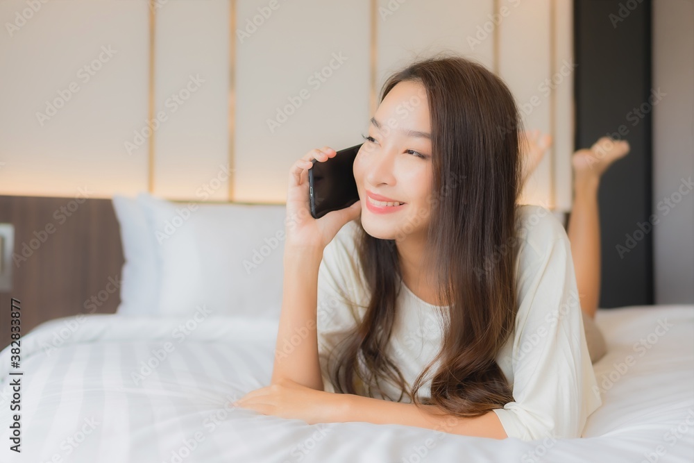 Portrait beautiful young asian woman use smart mobile phone on bed Portrait beautiful young asian woman use smart mobile phone on bed