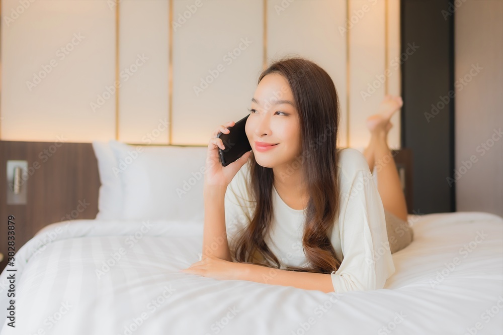 Portrait beautiful young asian woman use smart mobile phone on bed Portrait beautiful young asian woman use smart mobile phone on bed