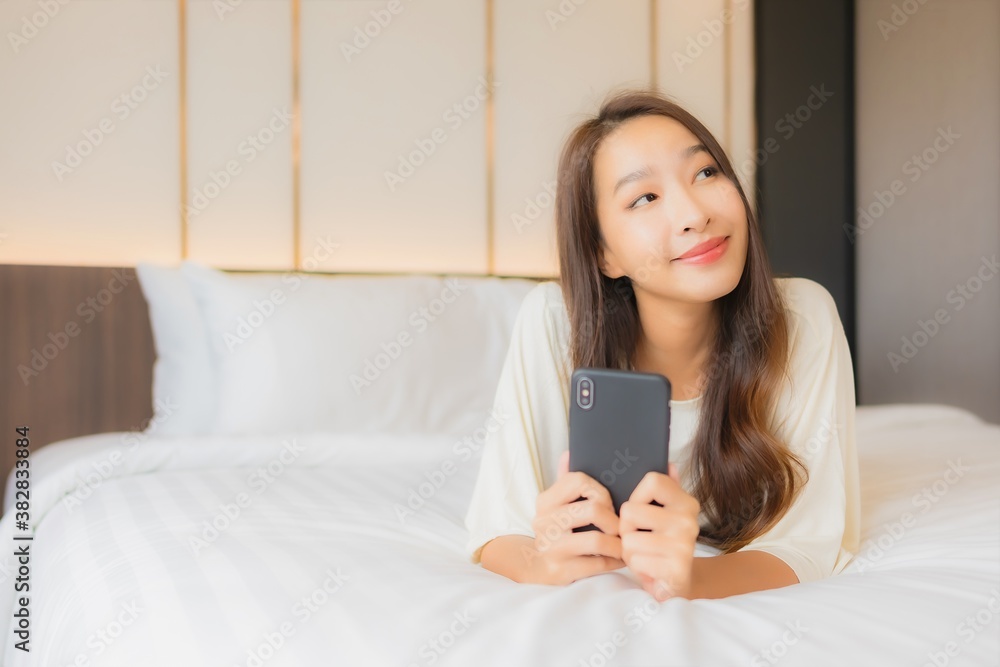Portrait beautiful young asian woman use smart mobile phone on bed Portrait beautiful young asian woman use smart mobile phone on bed