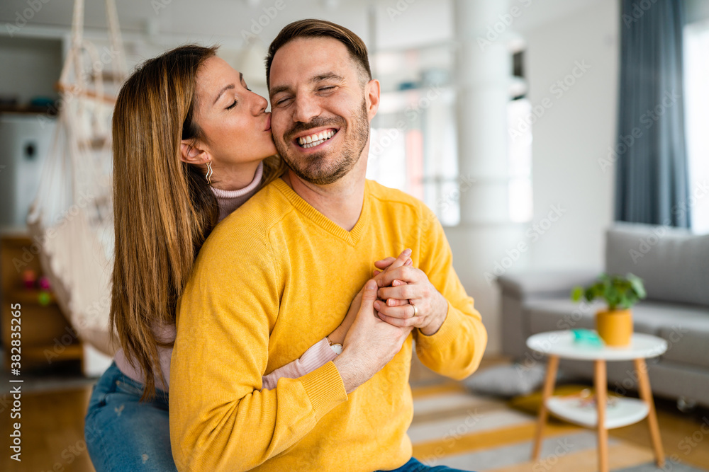 Fototapeta premium Beautiful couple in love is enjoying the company of each other at home.