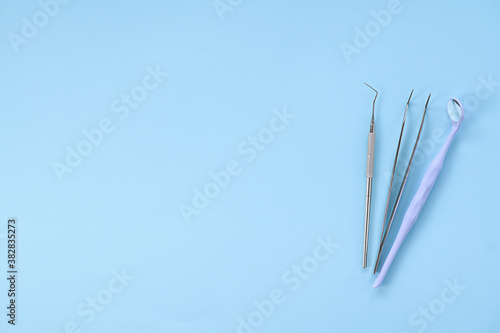 Dental tools on blue background  top view