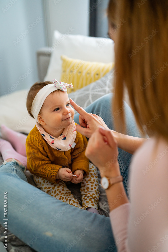 Happy loving family. Mother and child girl playing, kissing and hugging Happy loving family. Mother and child girl playing, kissing and hugging