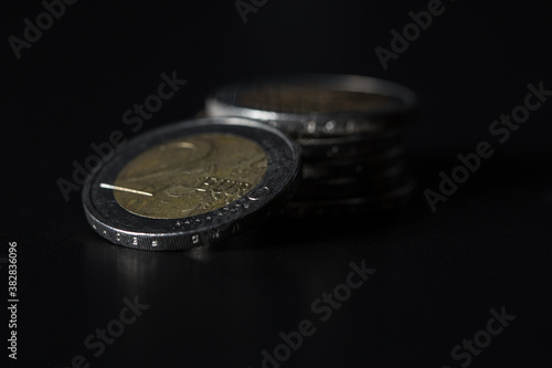 2 euro coin with blurred stack behind 