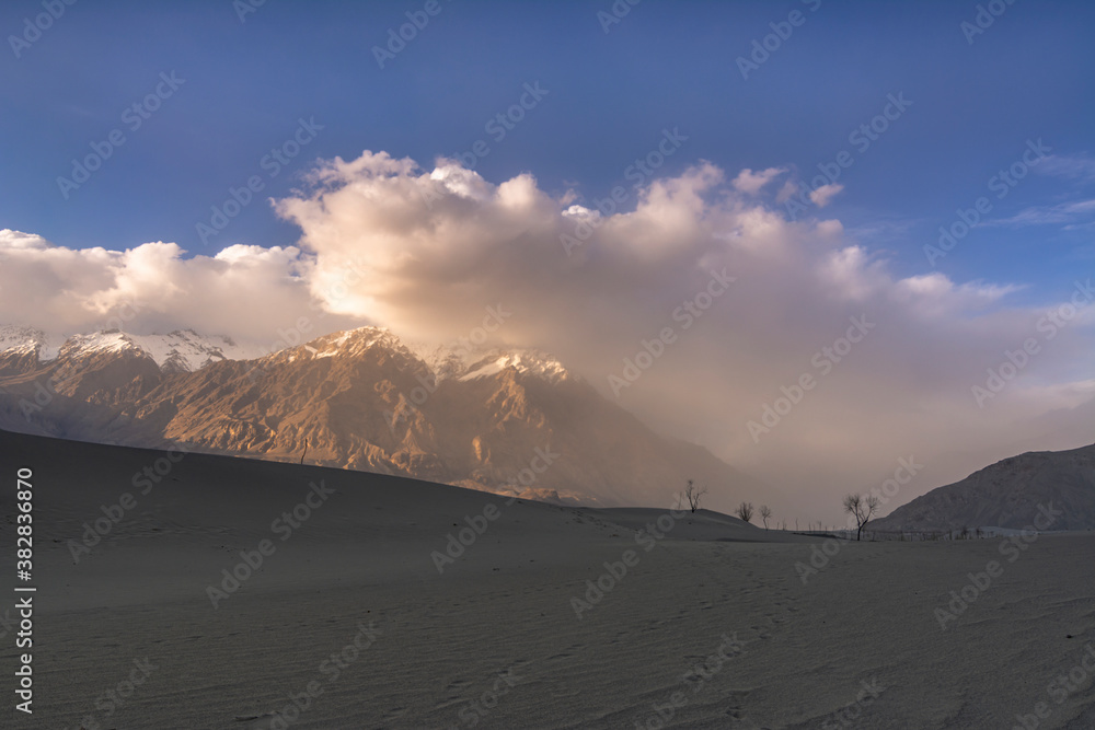 cold desert of katpana with snow mountains in background in northern ...