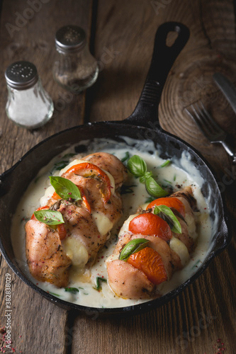 Chicken fillet baked with mozzarella tomatoes and basil