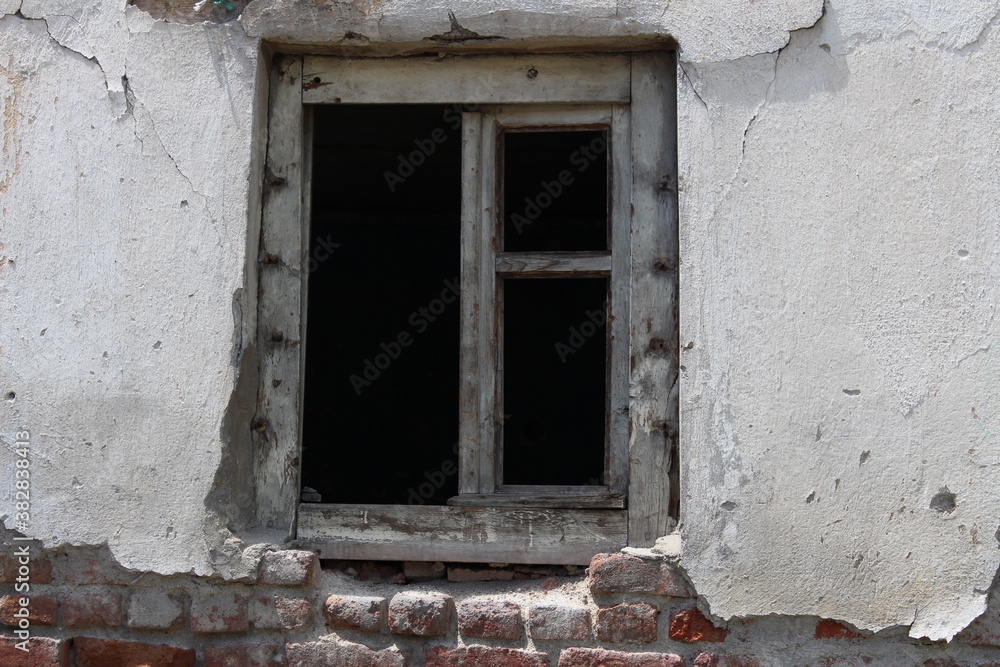Looking into the pitch black from the window of an old abandoned house. Looking into the dark gives the feeling of watching a horror movie. Looking into the pitch black from the window of an old abandoned house. Looking into the dark gives the feeling of watching a horror movie.