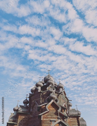 Wallpaper Mural Wooden orthodox church domes in the blue sky with clouds Torontodigital.ca
