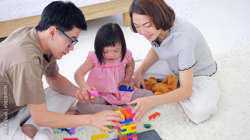 Happy family with mother, father and disabled daughter spending time together at home..