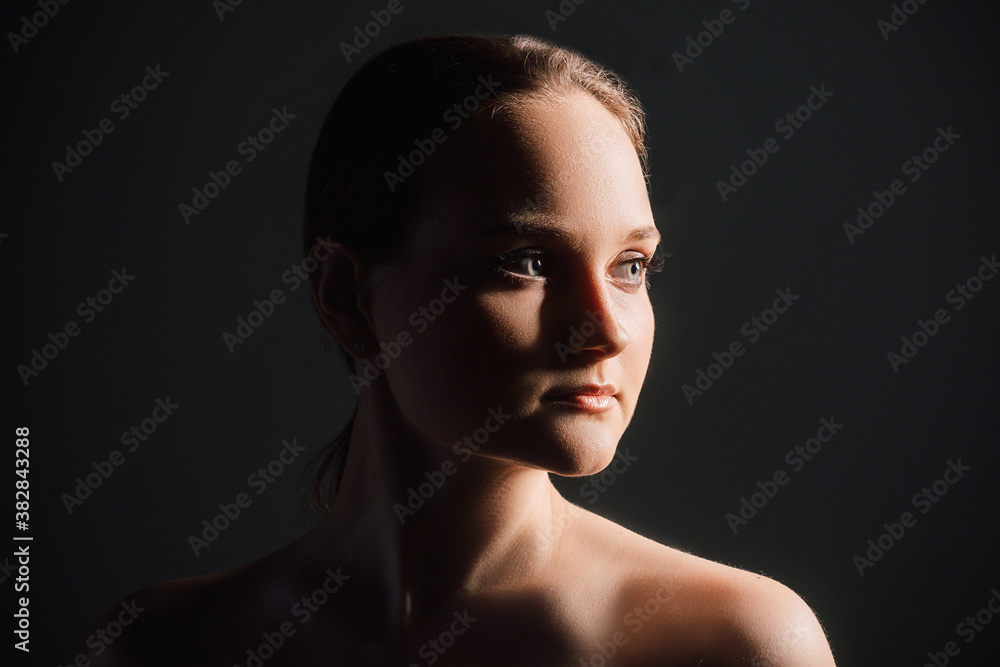 Fototapeta premium Woman portrait. Skin rejuvenation. Confident lady with bare shoulders isolated on black copy space background. Face contouring. Lip augmentation. Anti-aging procedure. Skincare wellness.