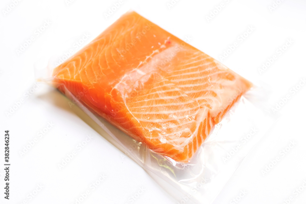 Fresh salmon fillet in vacuum package isolated on white background for delicious salmon steak. Fresh salmon fillet in vacuum package isolated on white background for delicious salmon steak.