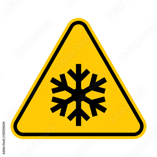 Low temperature hazard symbol. Vector illustration of yellow triangle warning sign with snowflake icon inside. Beware very cold temperature. Caution sign isolated on white background.