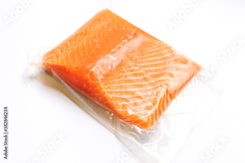 Fresh salmon fillet in vacuum package isolated on white background for delicious salmon steak. 