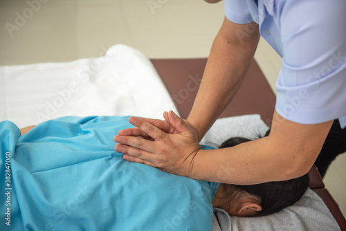 The patient is being treated by a physical therapist.