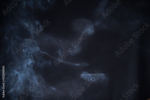 Quadro su tela Smoke in motion on dark background