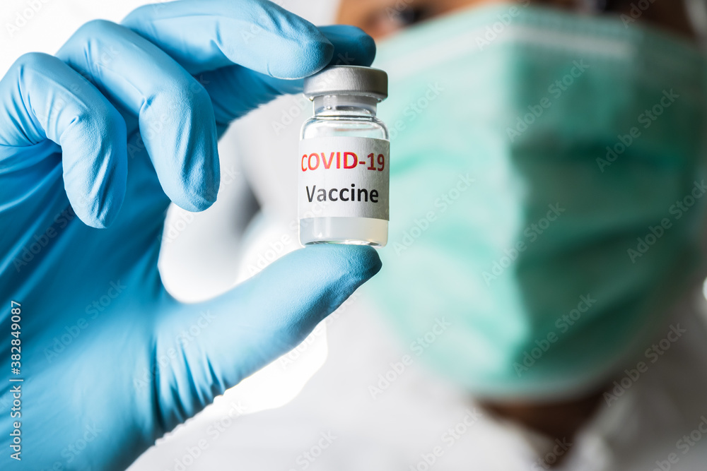 Doctor, nurse, scientist or researcher holding coronavirus (covid-19) vaccine for clinical trials in human Doctor, nurse, scientist or researcher holding coronavirus (covid-19) vaccine for clinical trials in human