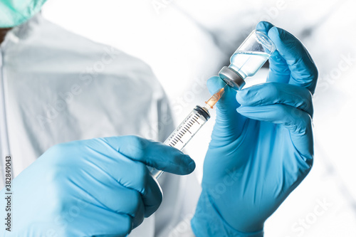 Doctor, nurse, scientist or researcher  holding coronavirus (covid-19) vaccine for clinical trials in human