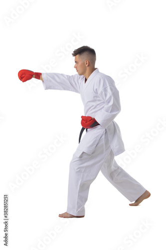 Man training taekwondo on white