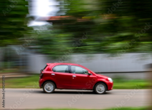 red car in motion with blurred background