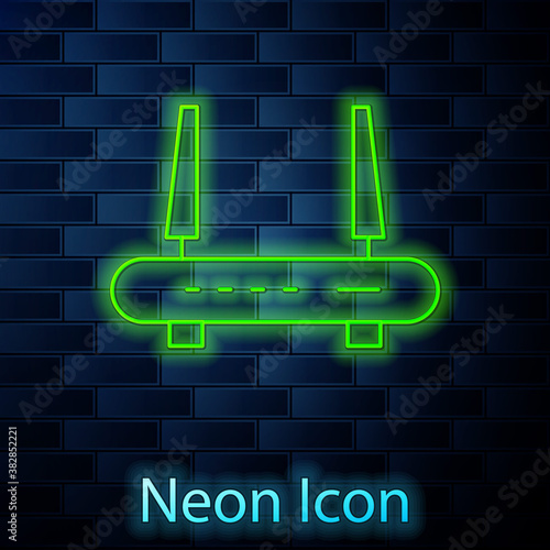 Glowing neon Router and wi-fi signal icon isolated on brick wall background. Wireless ethernet modem router. Computer technology internet. Vector.