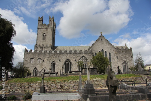 Stone church with cemetery next door and some greenery in Limerick